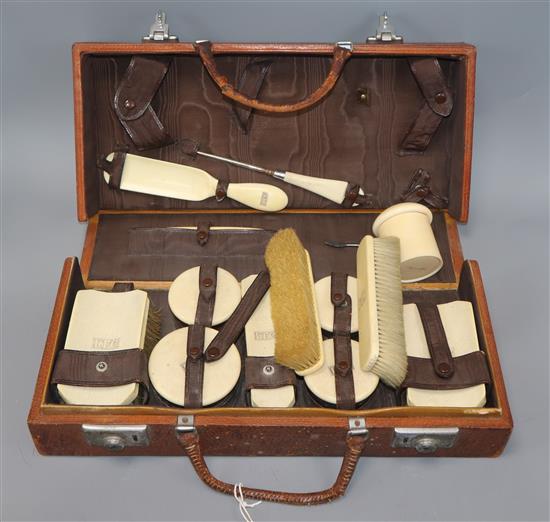 An ivory brush set in a leather bound case